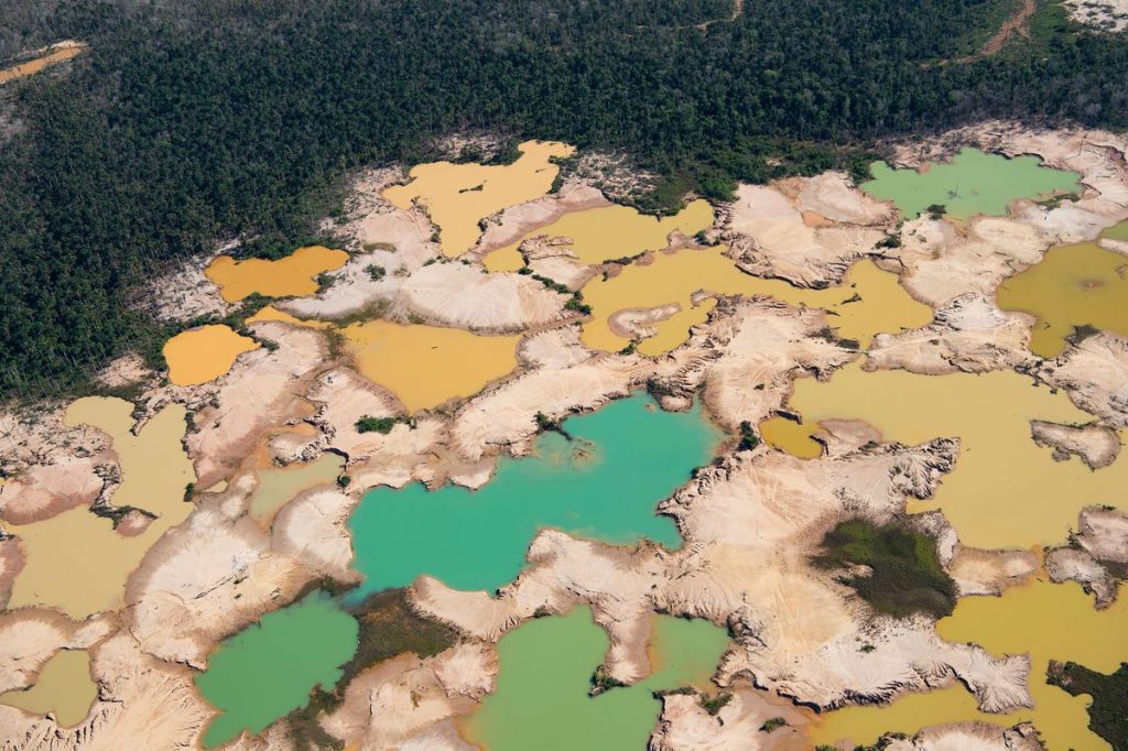 An aerial view over a chemically deforested area of the Amazon jungle caused by illegal mining activities in the river basin of the Madre de Dios region in southeast Peru.