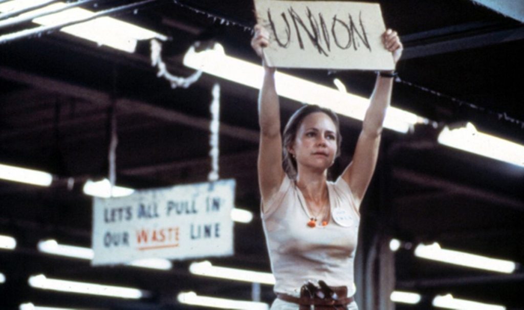 Norma Rae screencap of Sally Fields holding a “UNION” sign