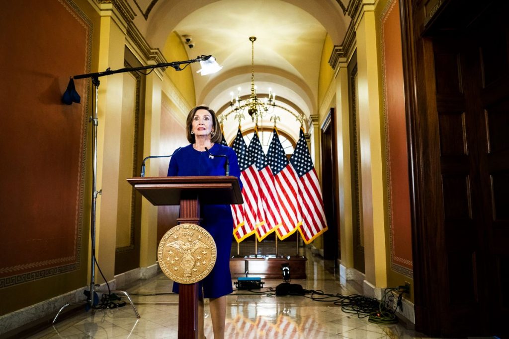 Speaker of the House Representative Nancy Pelosi speaks to the press at a podium set up in a hallway outside her office.