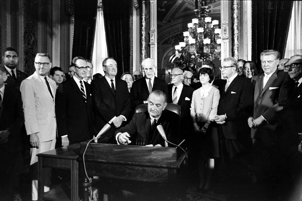 President Lyndon B. Johnson signs the Voting Rights Act of 1965.