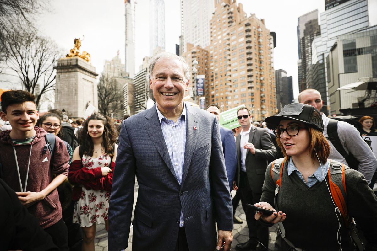 Former Democratic presidential candidate Washington Gov. Jay Inslee walking with a group of students down a New York City street.