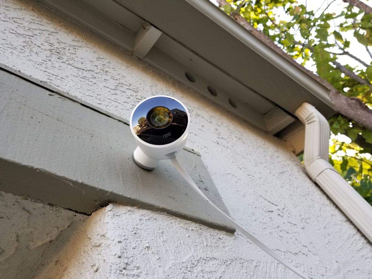 A Nest camera is mounted on a house.