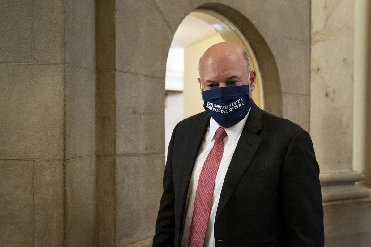 Postmaster General Louis DeJoy wearing a face mask with “United States Postal Service” written on it.