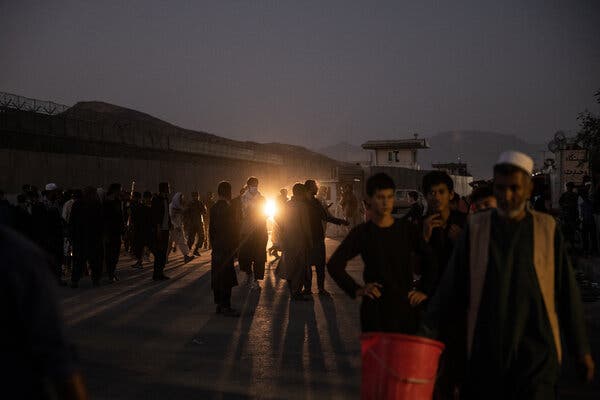 Afghans outside Kabul’s airport on Thursday. While most Afghans trying to escape the city have gone to the airport, the C.I.A. has shepherded hundreds of others, at particular risk of reprisals, to a base it destroyed on Thursday.